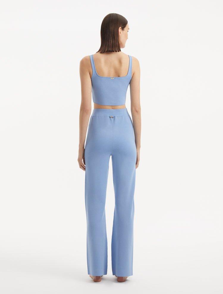 "Model wearing the Moira Baby Blue Pants from the back, emphasizing the high-waisted cut and wide-leg style. "