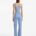 "Model wearing the Moira Baby Blue Pants from the back, emphasizing the high-waisted cut and wide-leg style. "