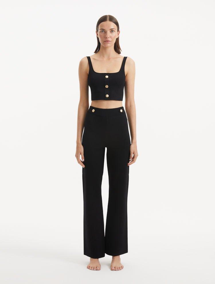 "Model wearing the Moira Black Pants from the front, highlighting the high-waisted design and wide-leg cut. "