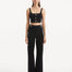 "Model wearing the Moira Black Pants from the front, highlighting the high-waisted design and wide-leg cut. "