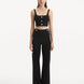 "Model wearing the Murphy Black Top and Moira Pants from the front, highlighting the high-waisted design and wide-leg cut. "