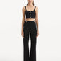 "Model wearing the Moira Black Pants from the front, highlighting the high-waisted design and wide-leg cut. "