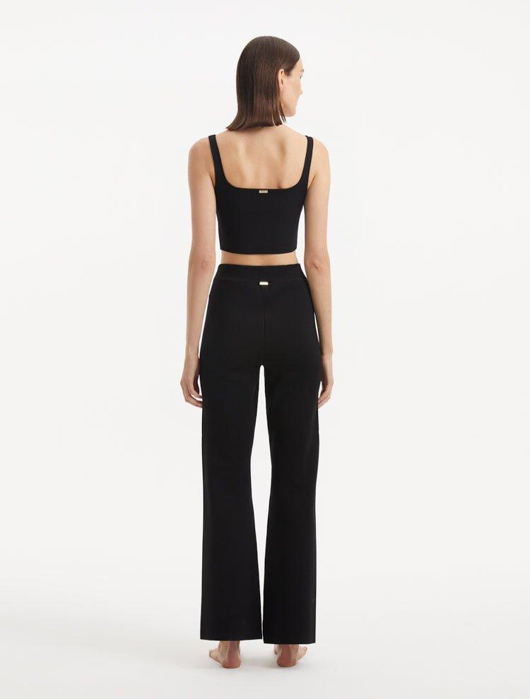 "Model wearing the Moira Black Pants from the back, showcasing the high-waisted style and wide-leg silhouette."