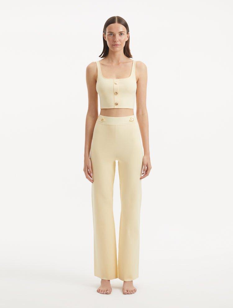 "Model wearing the Moira Yellow Pants from the front, highlighting the high-waisted design and wide-leg cut."