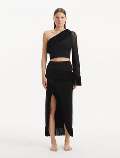 "Model wearing the Monroe Black Top from the front, showcasing the one-shoulder design and cropped silhouette. "