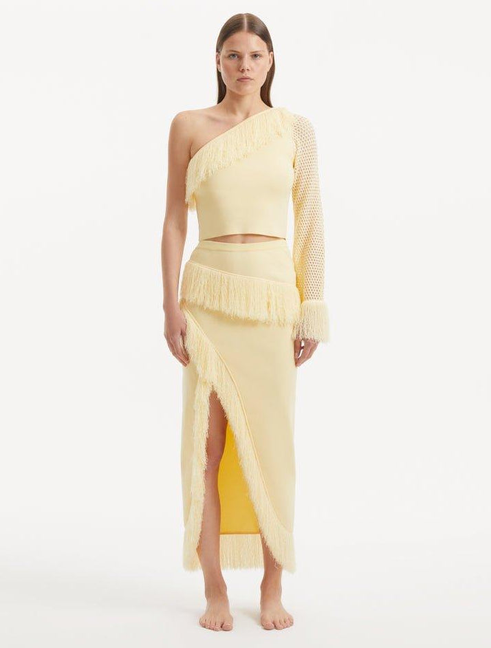 Monroe Yellow One-Shoulder Knit Top with Fringe & Mesh Sleeve | Moeva | Crop Top | Each week unveils new pieces—luxury swimwear, fluid resort silhouettes, and elevated summer-to-evening essentials designed to carry you from coastal escapes to city nights.