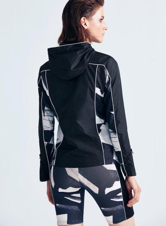 "Back view of the Morgan Abstract Print/Black Jacket, highlighting the hooded design and bold abstract print. "