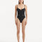 Model showcasing the Muriel Black Swimsuit with a central V-shape detail, highlighting its elegant and fluid design.