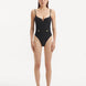 Model showcasing the Muriel Black Swimsuit with a central V-shape detail, highlighting its elegant and fluid design.
