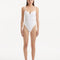 Model showcasing the Muriel White Swimsuit with an elegant V-shape detail at the front, highlighting its fluid and flattering design.