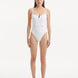 Model showcasing the Muriel White Swimsuit with an elegant V-shape detail at the front, highlighting its fluid and flattering design.