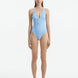 Model showcasing the Naida Baby Blue Swimsuit with a V-neck design and shell-shaped gold buttons, highlighting its elegant and athletic look.