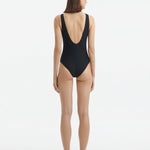 Back view of the Naida Black Swimsuit, highlighting the fit and moderate bottom coverage.