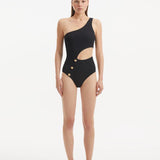 Model wearing the Narella Black Swimsuit, showcasing the elegant one-shoulder design and cutout detail.