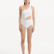 Model showcasing the Narella White Swimsuit, highlighting the elegant one-shoulder design and cutout detail.