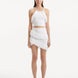 "Model showcasing the Nebula White Knit Top from the front, highlighting the pristine white color, intricate knit patterns, and elegant tie-neck detail. "