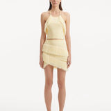 "Model wearing the Nebula Yellow Top and Arlo Yellow Skirt from the front, showcasing the vibrant yellow color, delicate knitting patterns, and distinctive tie-neck detail. "