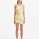 "Model wearing the Nebula Yellow Top and Arlo Yellow Skirt from the front, showcasing the vibrant yellow color, delicate knitting patterns, and distinctive tie-neck detail. "