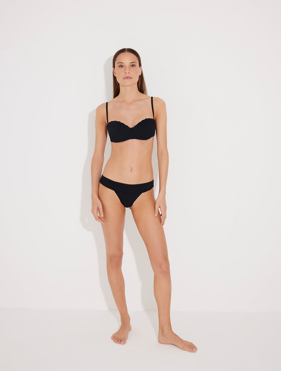 Front View: Model in Nicoletta Black Bikini Top - Strapless, Bandeau Style, Molded Cup with Push-Up, Embroidery Details, Push-Up Swim Top, MOEVA Luxury Swimwear  