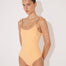 "Model wearing the Ninetta Orange Scoop Neck Swimsuit from the front. The swimsuit features elegant geometrical chain straps and handmade topstitching details that accentuate the body's natural lines. "