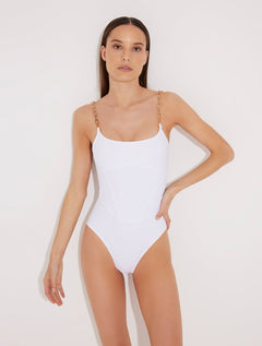 Front View: Model in Ninetta White Swimsuit - MOEVA Luxury Swimwear, Scoop Neck, Slimming Effect Stitch Detail, Adjustable Geometric Chain Straps, Removable Padding, Italian Fabric, MOEVA Luxury Swimwear 