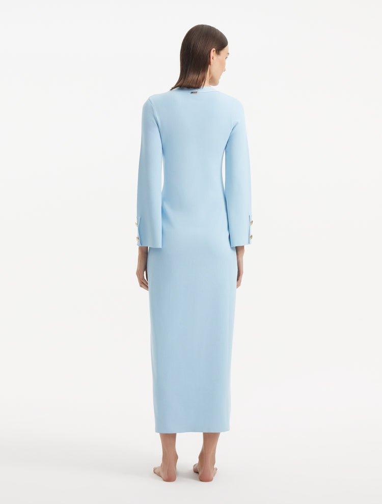 "Model showcasing the Nira Baby Blue Dress from the back, emphasizing the flowing, ankle-length finish and the soft baby blue color. "