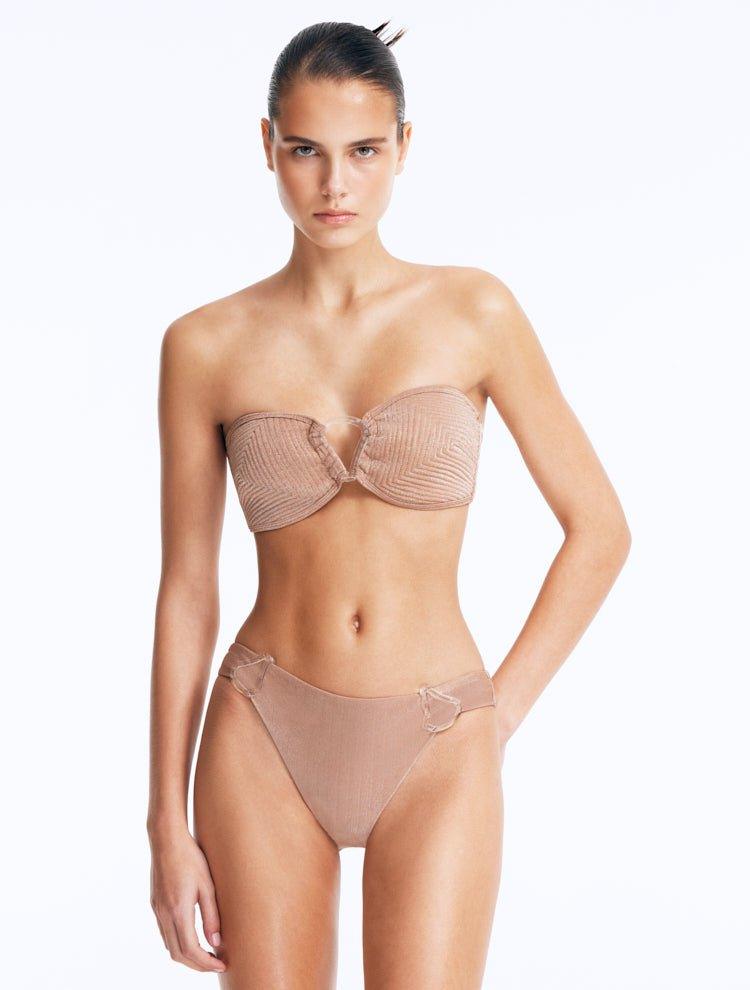 Front View: Model Wearing Nixie Bronze Bikini Set- Bandeau Shape, Chic and Accessorized, Metallic Fabric, Clear Glass Drop Shaped Accessory, MOEVA Luxury Swimwear
