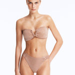 Front View: Model Wearing Nixie Bronze Bikini Set- Bandeau Shape, Chic and Accessorized, Metallic Fabric, Clear Glass Drop Shaped Accessory, MOEVA Luxury Swimwear