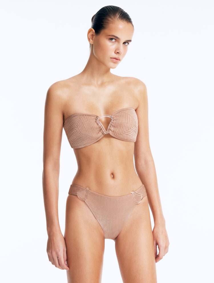 Front View: Model in Nixie Bronze Bikini Bottom - Classic Briefs, Chic Style, Metallic Fabric, Clear Glass Drop Shaped Accessories, MOEVA Luxury Swimwear