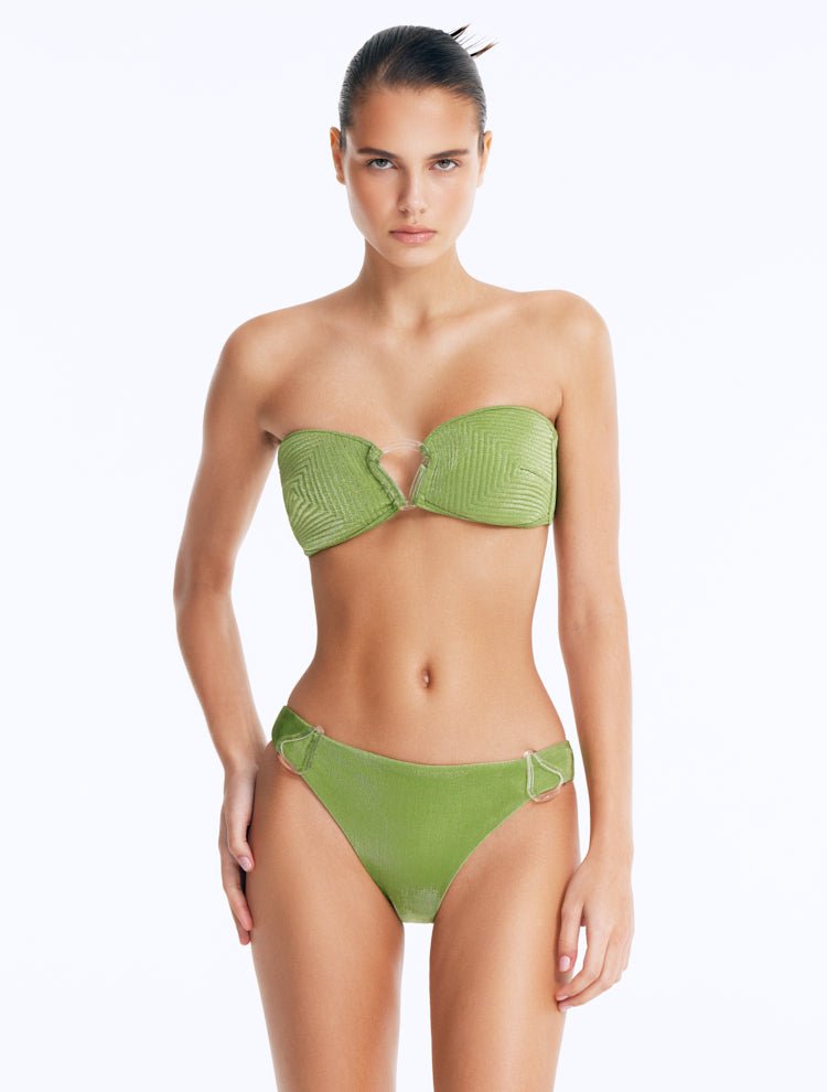 Front View: Model Showcasing Nixie Green Bikini Top - Bandeau Style, Chic and Accessorized, Metallic Fabric, Clear Glass Drop Shaped Accessory, MOEVA Luxury Swimwear