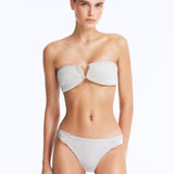Front View: Model Wearing Nixie Silver Bikini Top - Bandeau Style, Chic and Accessorized, Metallic Fabric, Clear Glass Drop Shaped Accessory, MOEVA Luxury Swimwear