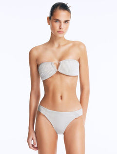 Model wearing the Nixie Silver Bikini Set, showcasing the bandeau top with clear glass drop accents.
