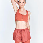 "Front view of Ondine Red Ochre Shorts showing double-layered design, stretchable fabric, and adjustable waistband. The thigh-length shorts are fitted and stylish, ideal for various activities."