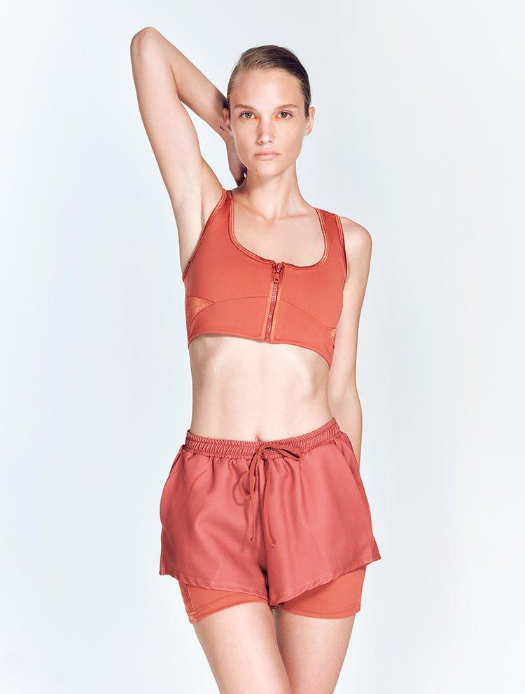 "Front view of Ondine Red Ochre Shorts showing double-layered design, stretchable fabric, and adjustable waistband. The thigh-length shorts are fitted and stylish, ideal for various activities."