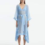"Model wearing the Opal Baby Blue Kaftan from the front, highlighting the V neckline, knee-length cut, and self-tie belt."