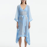 "Model wearing the Opal Baby Blue Kaftan from the front, highlighting the V neckline, knee-length cut, and self-tie belt."