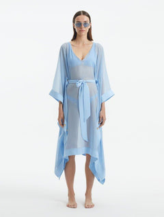 "Model wearing the Opal Baby Blue Kaftan from the front, highlighting the V neckline, knee-length cut, and self-tie belt."