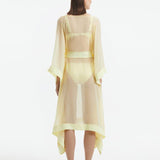 "Back view of the Opal Yellow Kaftan, featuring the shell-shaped gold button details and the sheer fabric."