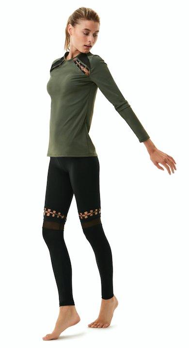  "Orla Black Leggings front view, showcasing bold mesh details and cut-out panel design. The stretchable fabric offers a snug, flexible fit."