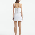 Back View: Model in Osaka White Dress - MOEVA Luxury Swimwear, Zip Through Back Fastening, Wrap Style Skirt, Mid-Thigh Length, Made of Swimwear Fabric, Special Lycra Xtralife Certificate, MOEVA Luxury Swimwear