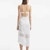 "Back view of the Pelagia White Pareo, highlighting the geometric details and the soft, flowing material."