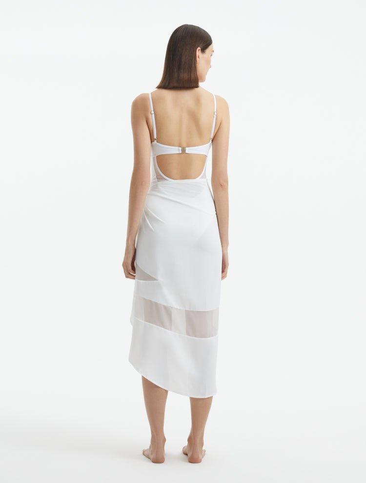 "Back view of the Pelagia White Pareo, highlighting the geometric details and the soft, flowing material."