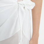 "Close-up of the Pelagia White Pareo’s fabric and geometric details, emphasizing the texture and intricate patterns."