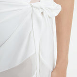 "Close-up of the Pelagia White Pareo’s fabric and geometric details, emphasizing the texture and intricate patterns."