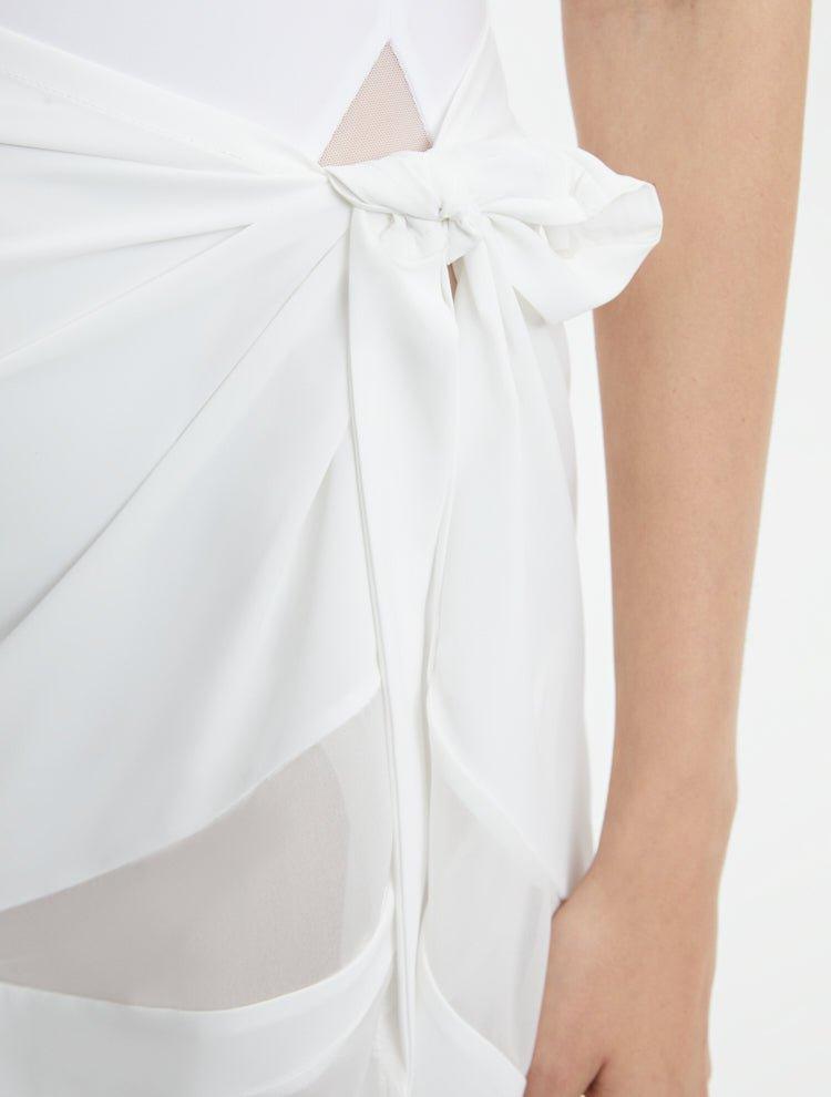 "Close-up of the Pelagia White Pareo’s fabric and geometric details, emphasizing the texture and intricate patterns."