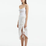 "Side view of the Pelagia White Pareo, showcasing its loose fit and the fluid, translucent fabric."