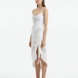 "Side view of the Pelagia White Pareo, showcasing its loose fit and the fluid, translucent fabric."