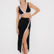 "Model wearing Pina Black/White Skirt from the front, highlighting its chic asymmetrical design and side slit."