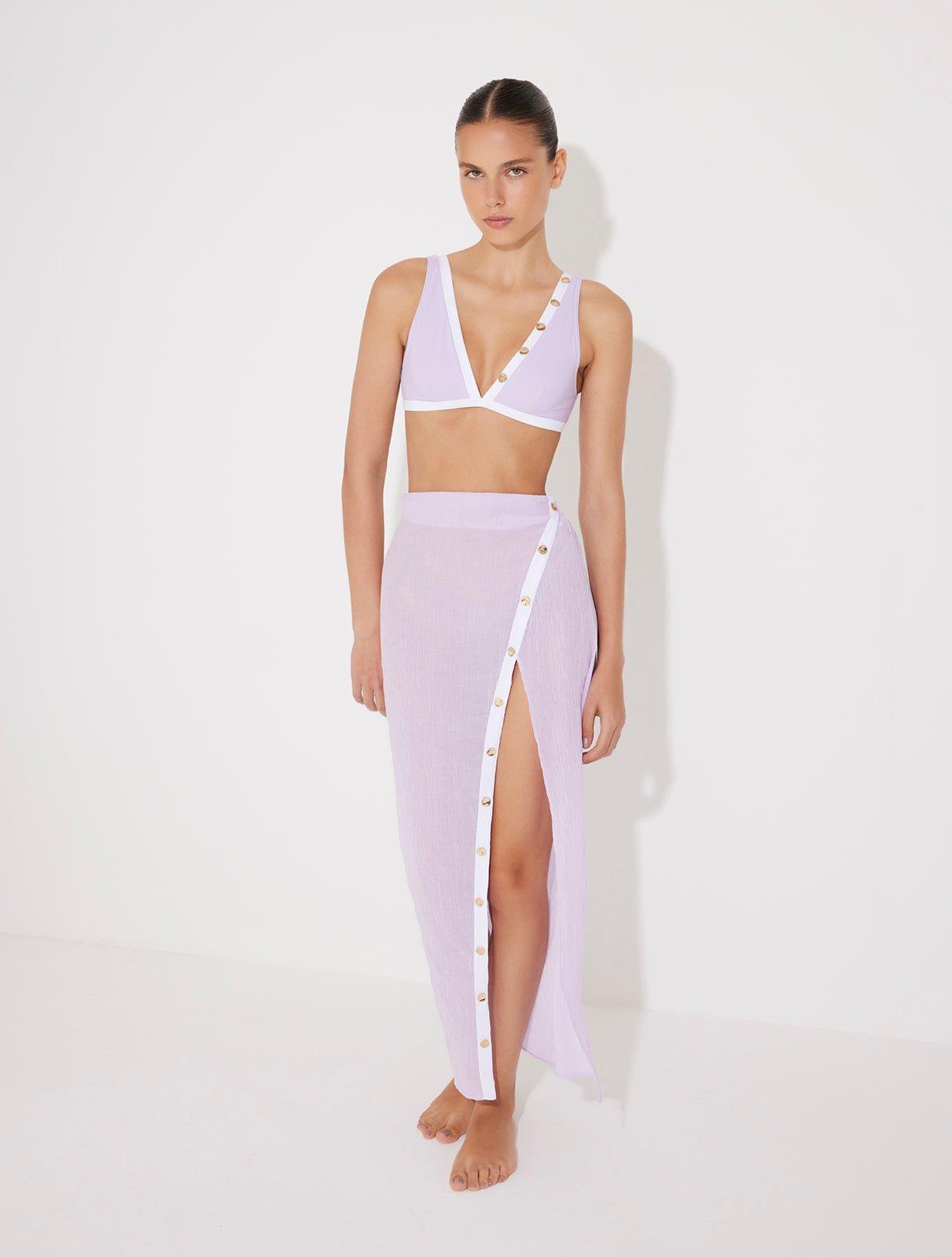 "Model wearing Pina Lilac/White Skirt from the front, highlighting its chic asymmetrical design and side slit."