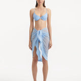 "Model wearing the Raiden Baby Blue Pareo from the front, highlighting the unique wavy detail and adjustable front tie."